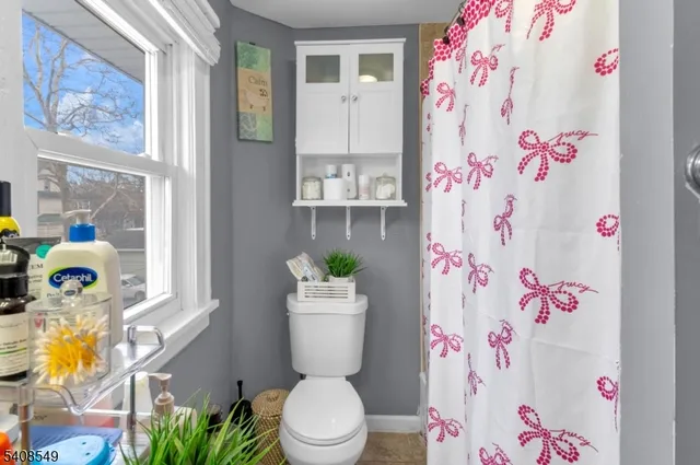 a bathroom with a sink mirror vanity and toilet