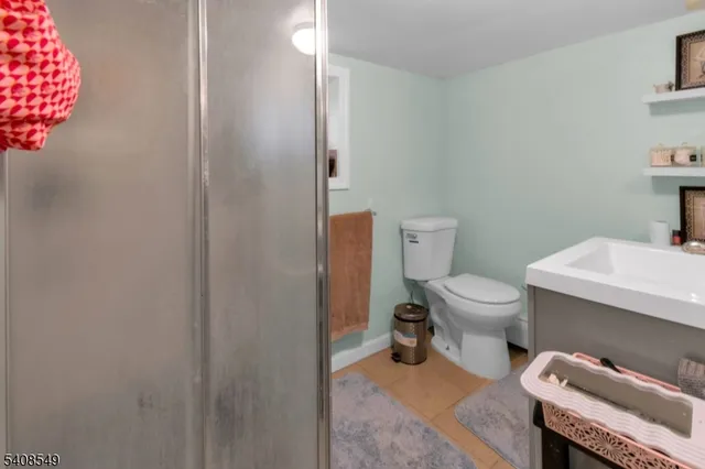 a white toilet sitting next to a bathroom sink