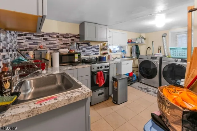 a utility room with sink dryer and bicycles
