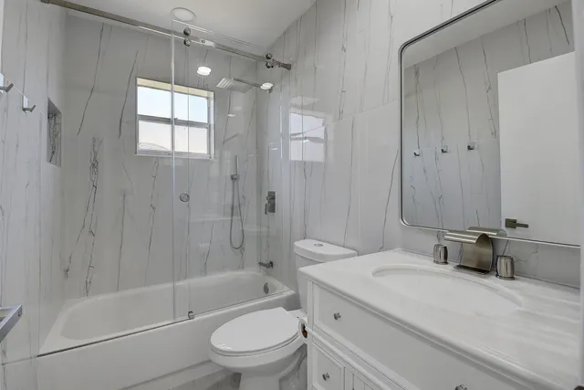 a kitchen with stainless steel appliances granite countertop a sink stove and microwave