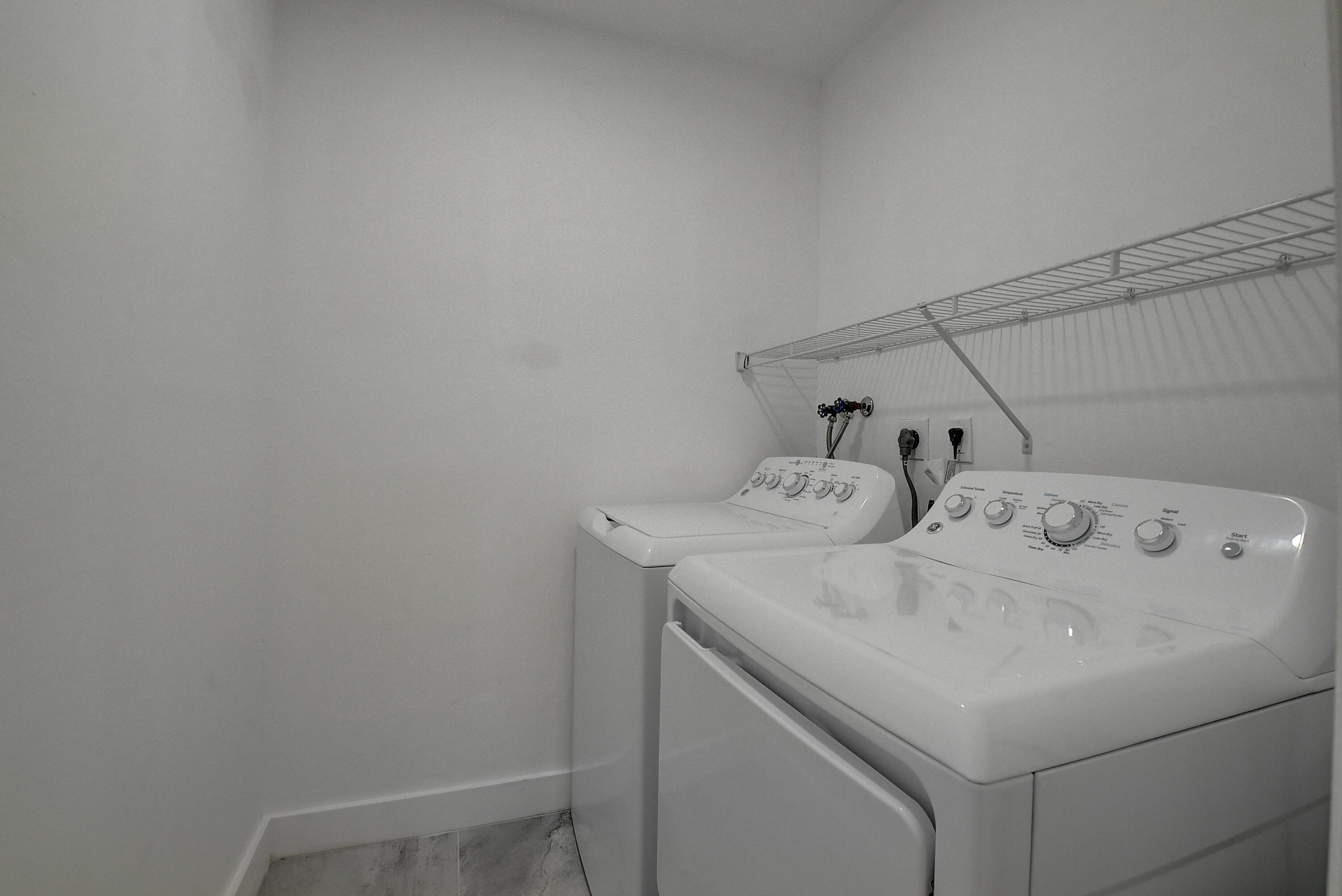 318 Monaco Boulevard, Unit G Delray Beach, FL 33446 - Photo 19 of 31 a utility room with dryer and washer