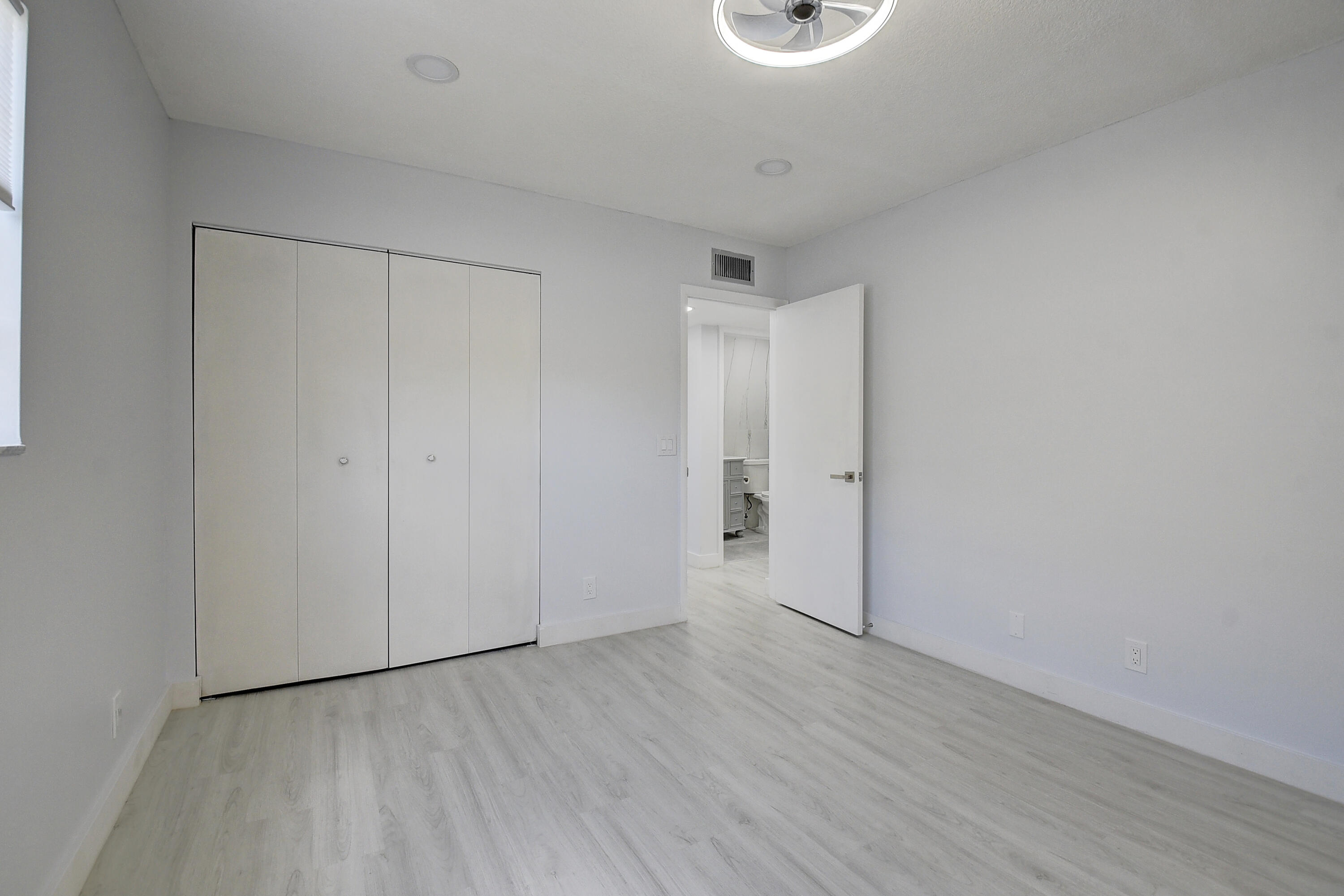 318 Monaco Boulevard, Unit G Delray Beach, FL 33446 - Photo 22 of 31 a view of an empty room with wooden floor