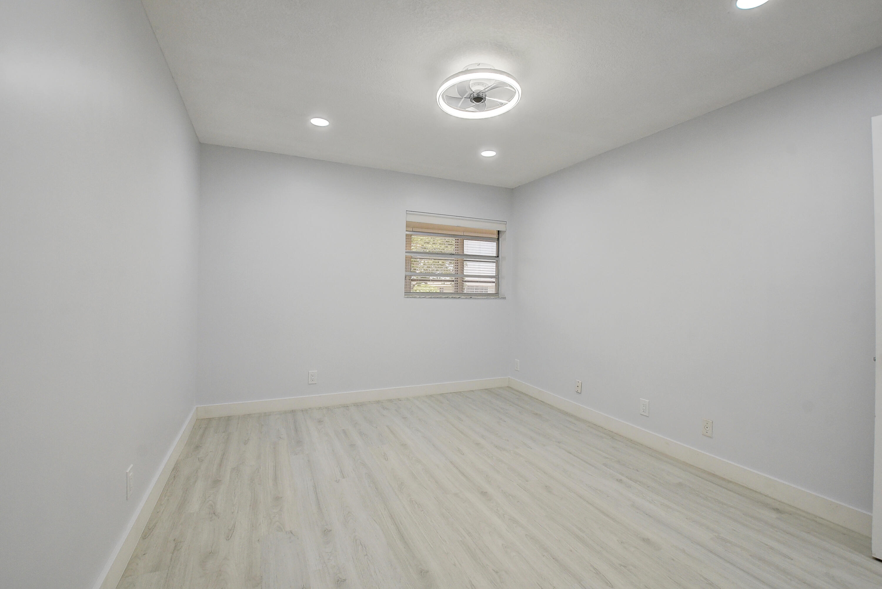 318 Monaco Boulevard, Unit G Delray Beach, FL 33446 - Photo 26 of 31 an empty room with a window