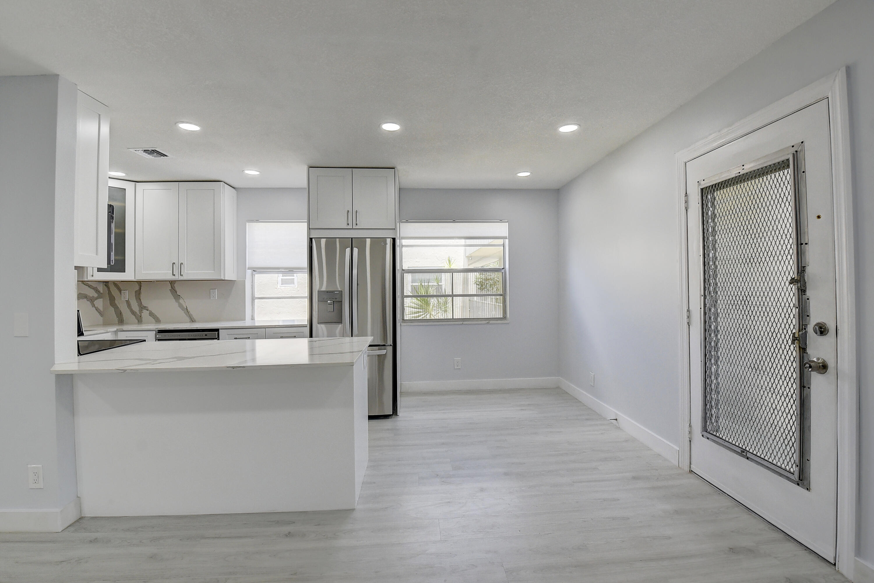 318 Monaco Boulevard, Unit G Delray Beach, FL 33446 - Photo 28 of 31 a view of kitchen with stainless steel appliances refrigerator oven and cabinets