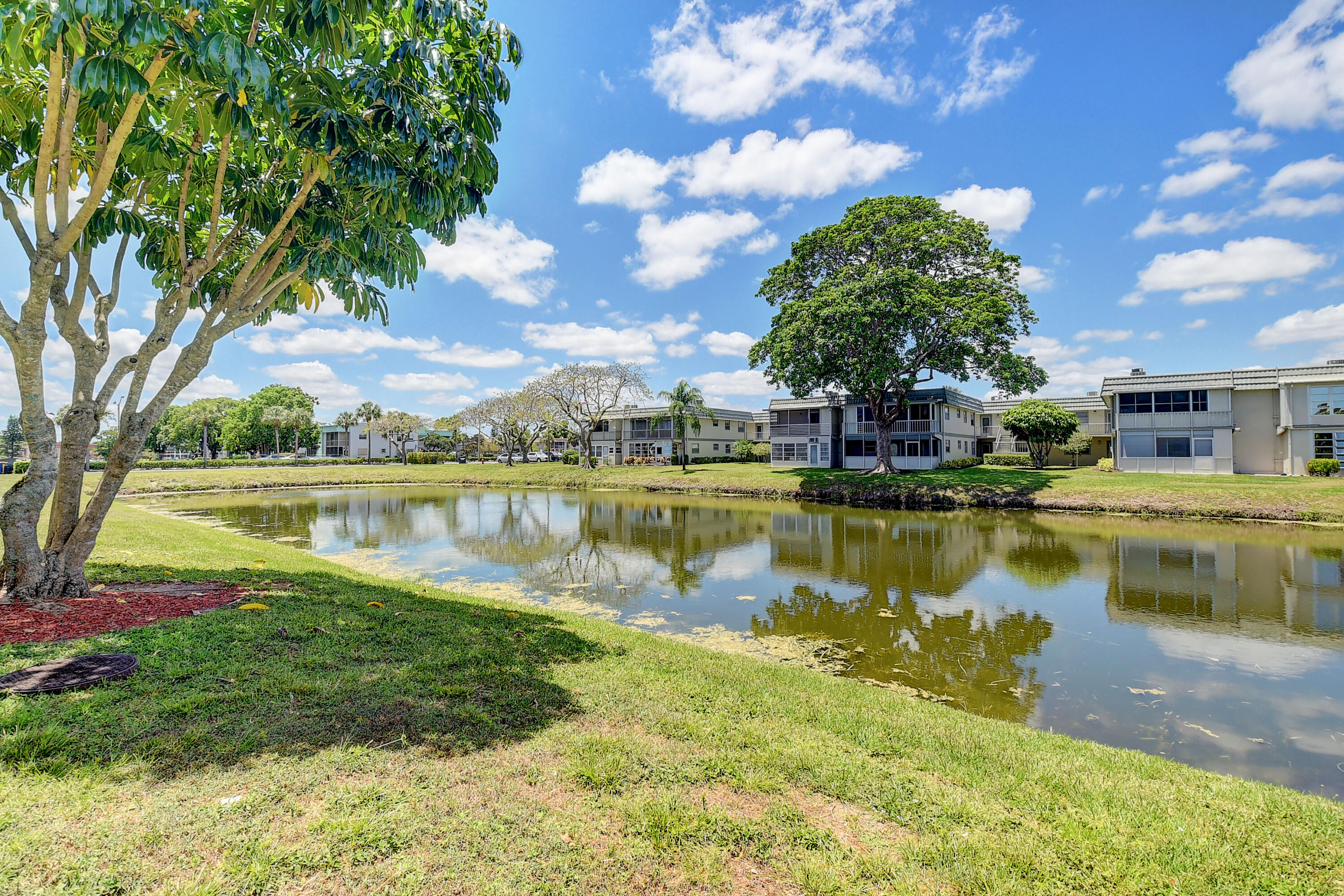 318 Monaco Boulevard, Unit G Delray Beach, FL 33446 - Photo 3 of 31 a view of a lake with houses