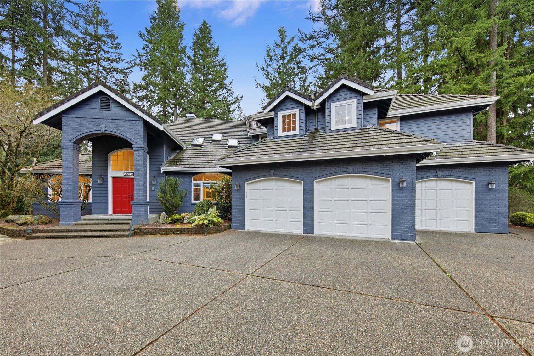 25305 Southeast 232nd Street Maple Valley, WA 98038 - Photo 1 of 33 a front view of a house with a yard and garage