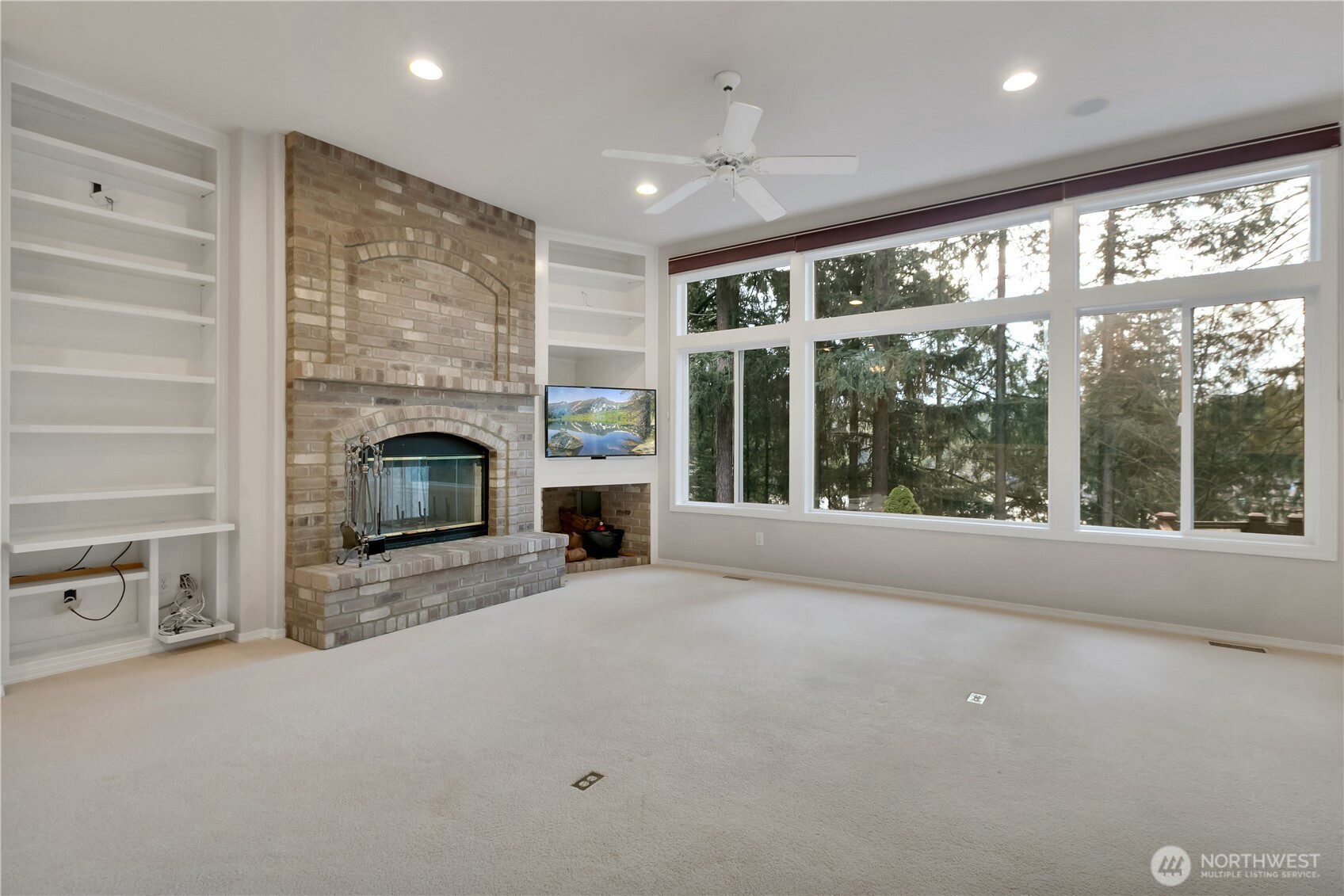 25305 Southeast 232nd Street Maple Valley, WA 98038 - Photo 13 of 33 a view of an empty room with a fireplace and a window