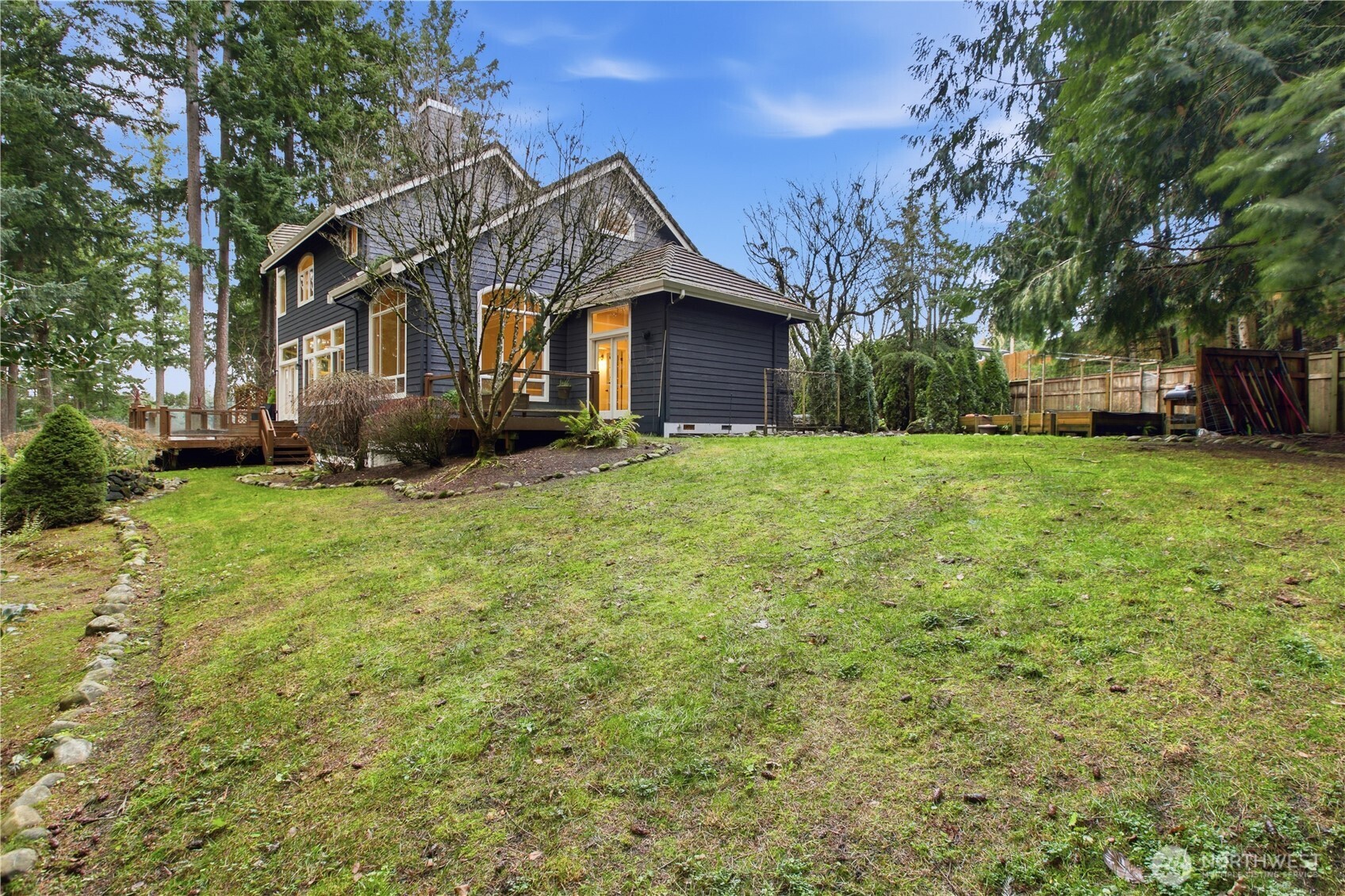 25305 Southeast 232nd Street Maple Valley, WA 98038 - Photo 25 of 33 a view of a house with a big yard and large trees