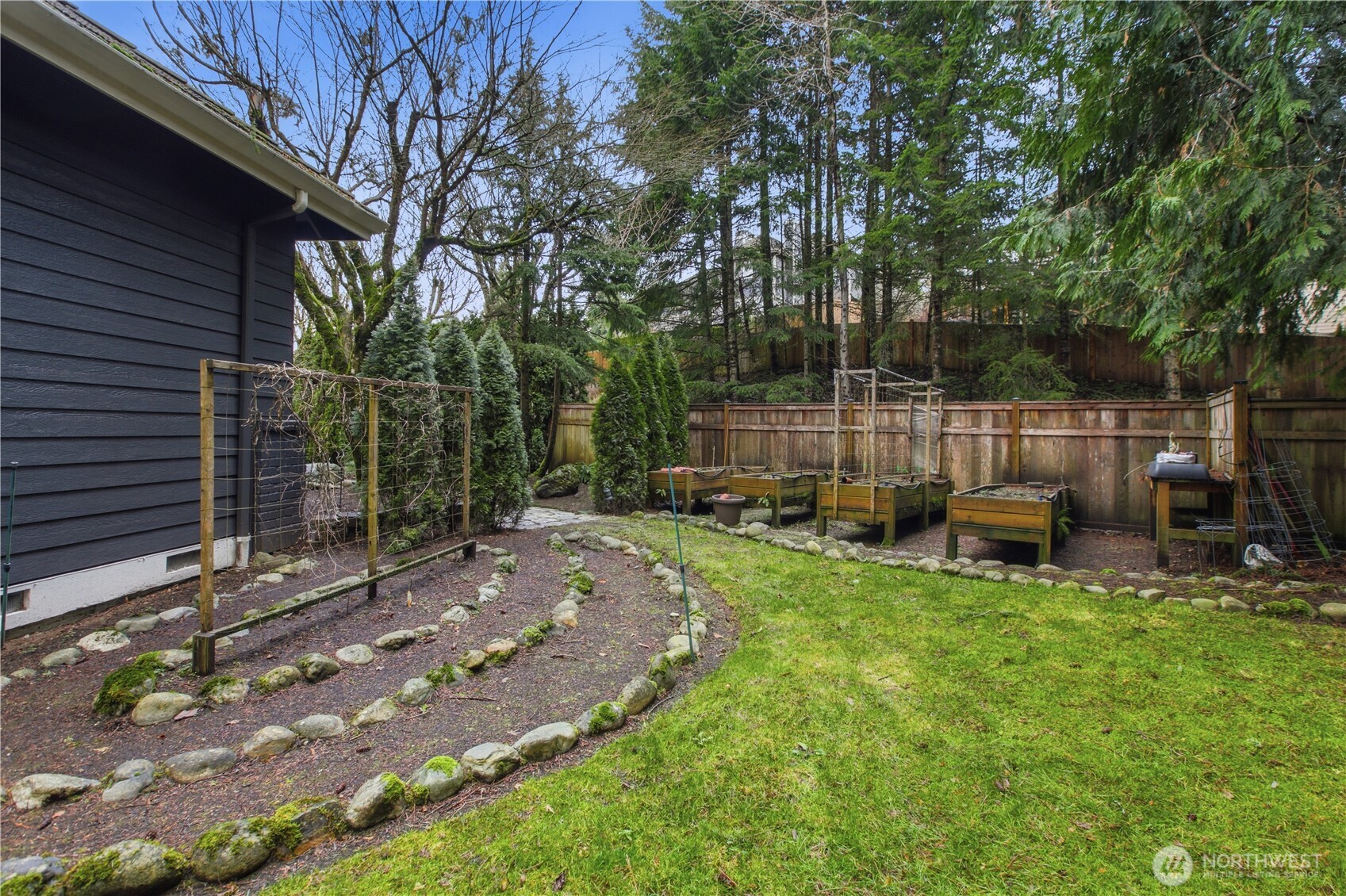 25305 Southeast 232nd Street Maple Valley, WA 98038 - Photo 26 of 33 a view of backyard with a table and chairs and a large tree