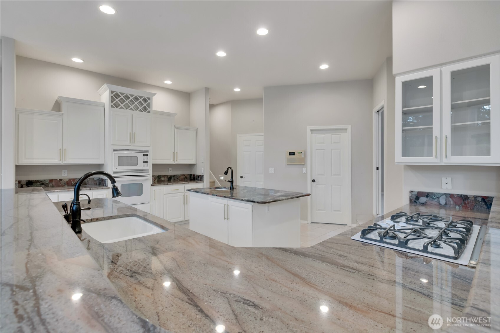 25305 Southeast 232nd Street Maple Valley, WA 98038 - Photo 3 of 33 a kitchen with counter top space a sink stainless steel appliances and cabinets