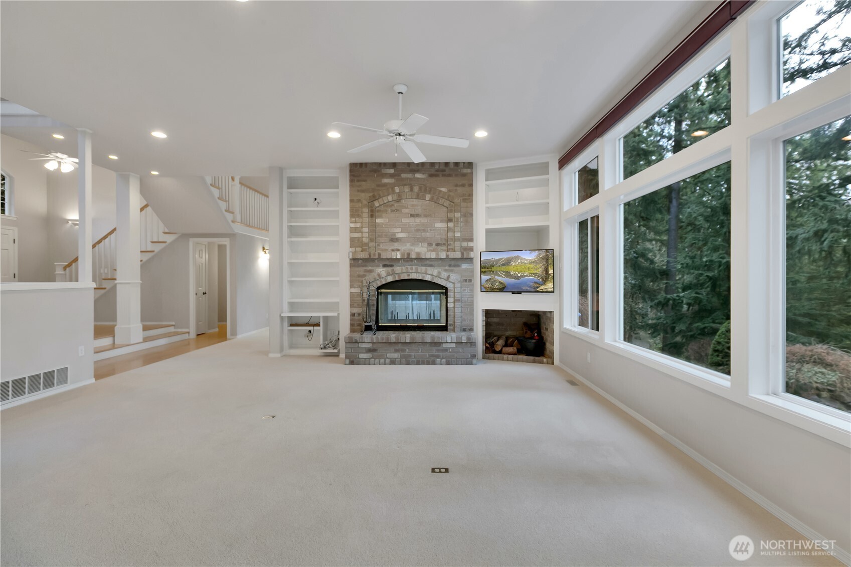 25305 Southeast 232nd Street Maple Valley, WA 98038 - Photo 9 of 33 a view of an empty room with a fireplace and a window