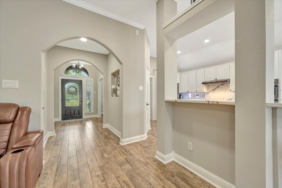 306 Sunset Ridge Drive League City, TX 77573 - Photo 12 of 50 a view of a hallway view with wooden floor and staircase