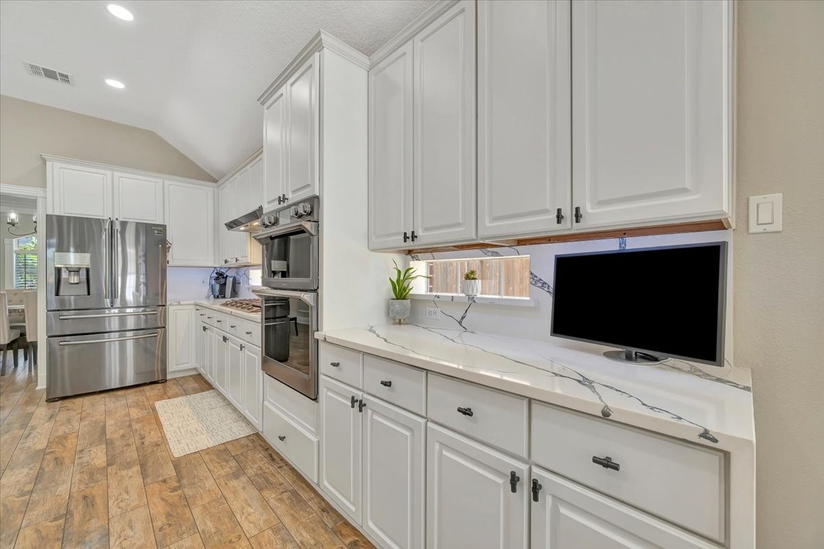 306 Sunset Ridge Drive League City, TX 77573 - Photo 19 of 50 a kitchen with granite countertop white cabinets and stainless steel appliances