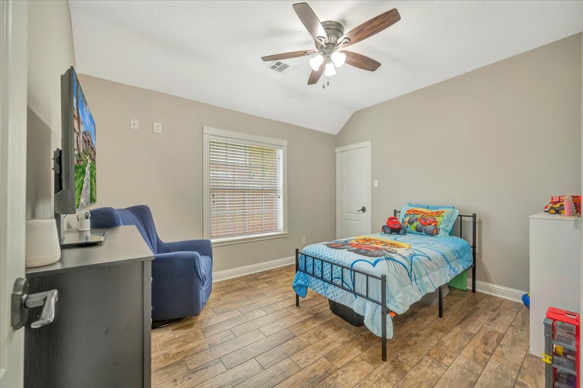 306 Sunset Ridge Drive League City, TX 77573 - Photo 27 of 50 a bedroom with a bed and a chandelier