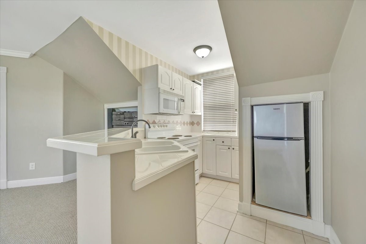 306 Sunset Ridge Drive League City, TX 77573 - Photo 33 of 50 a kitchen with a sink stainless steel appliances and cabinets