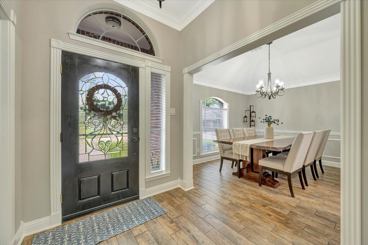 306 Sunset Ridge Drive League City, TX 77573 - Photo 7 of 50 a dining room with furniture a chandelier and wooden floor