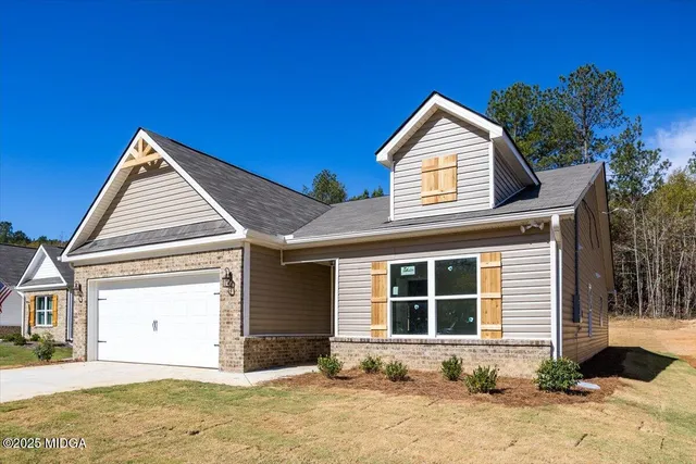 a view of a house with a yard and garage
