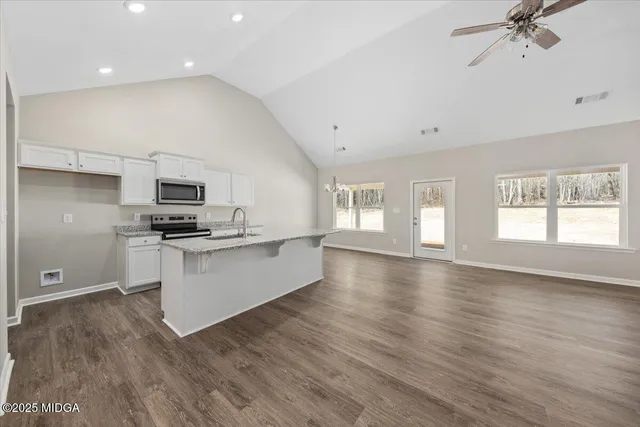 a kitchen with stainless steel appliances a refrigerator and stove