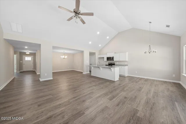 a view of kitchen with closet and wooden floor