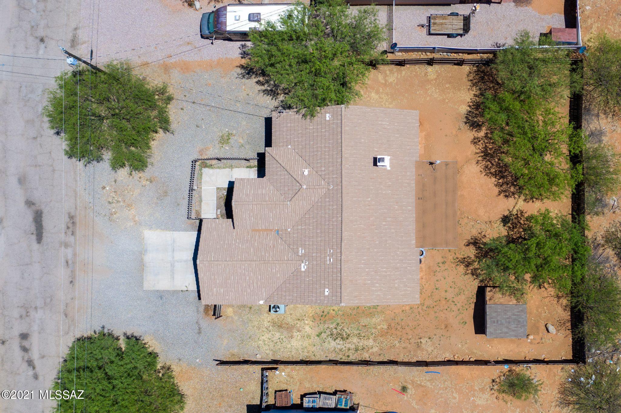 131 Alemania Court Rio Rico, AZ 85648 - Photo 7 of 47 an aerial view of a house with a yard and large trees