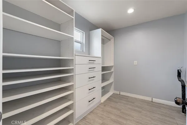 a kitchen with a stove a sink a kitchen island with chairs and wooden floor