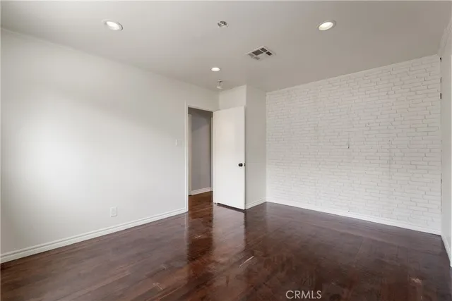 a spacious bedroom with a bed and a chandelier