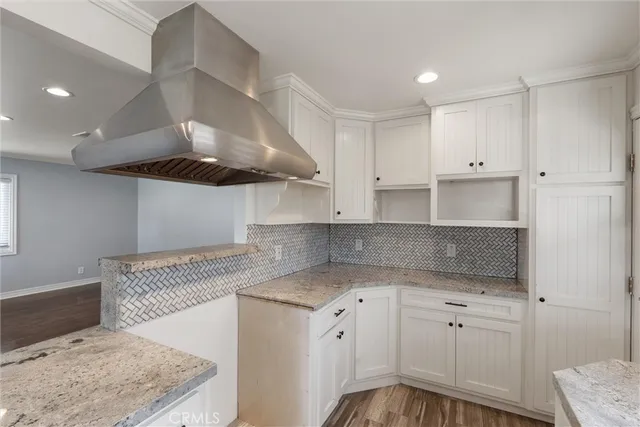 a kitchen with granite countertop a sink stainless steel appliances and cabinets
