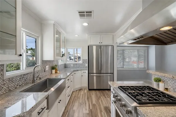 a dining room with furniture potted plants and wooden floor