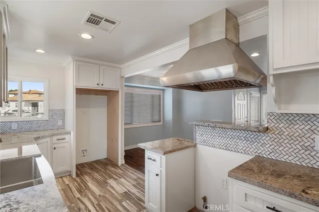 a view of a kitchen cabinets and wooden floor