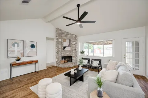 a living room with furniture fireplace and window