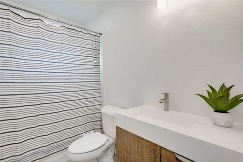 a view of a chair and table in backyard of the house