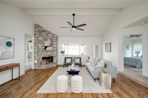 a living room with furniture fireplace and window