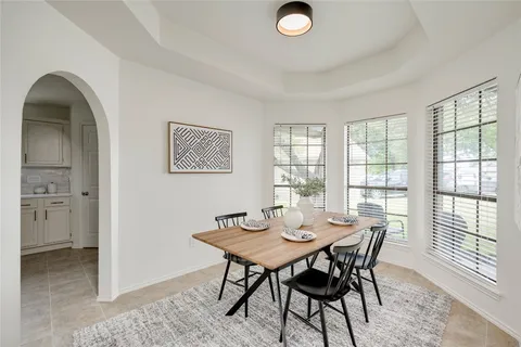 a view of a dining room with furniture and window
