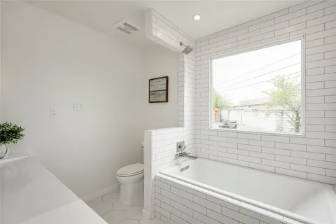 a bathroom with a bathtub and a toilet