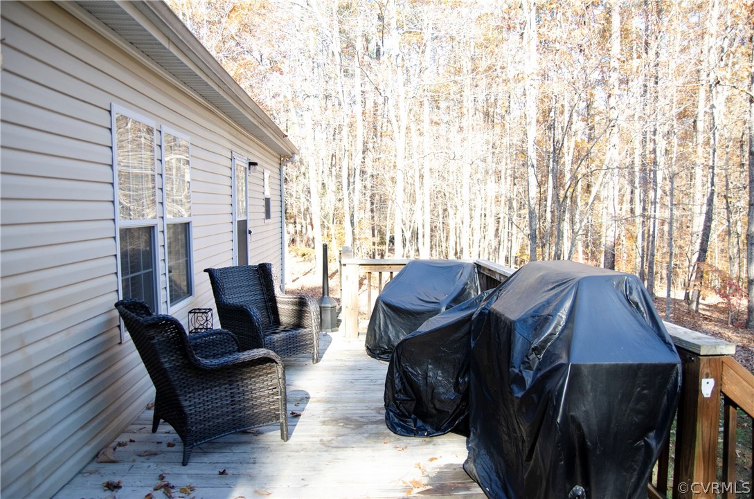 2861 Gold Mine Road Palmyra, VA 22963 - Photo 28 of 32 a view of a patio with chair and table and chairs with wooden floor and fence