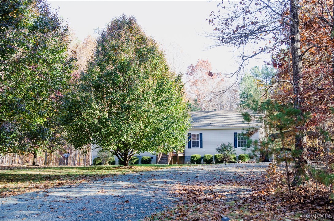 2861 Gold Mine Road Palmyra, VA 22963 - Photo 3 of 32 a front view of a house with a yard and trees