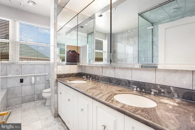a living room with furniture and a book shelf
