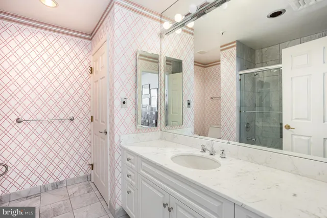 a bathroom with a sink a toilet and shower curtain