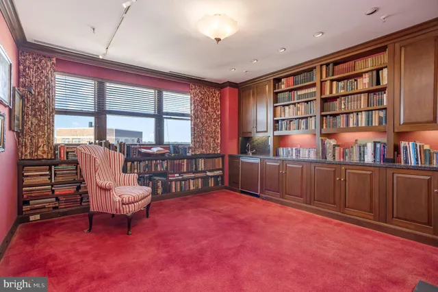 a view of a livingroom with furniture and a book shelf