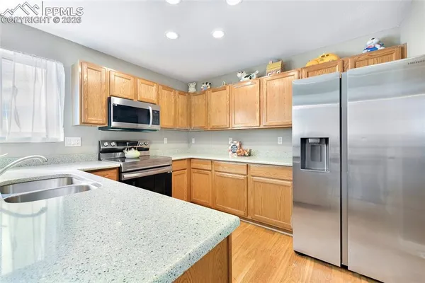 a kitchen with stainless steel appliances granite countertop a refrigerator a sink a stove a microwave and island