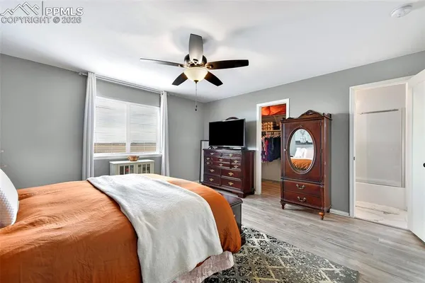 a bedroom with a bed a television and dresser