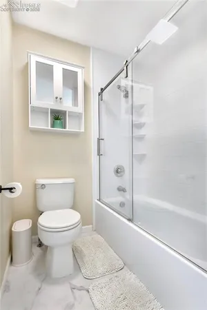 a bathroom with a toilet and a shower