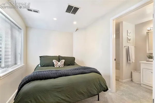 a bedroom with a bed and with furniture