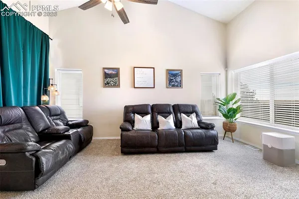 a living room with furniture and a potted plant
