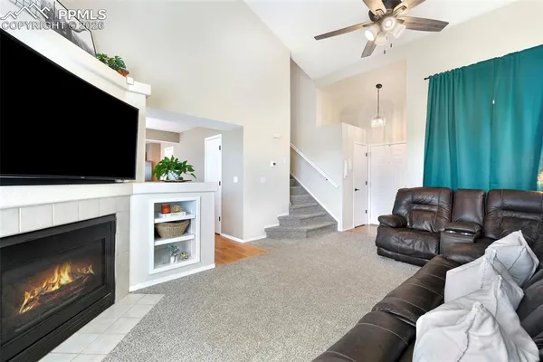 a living room with furniture and a fireplace