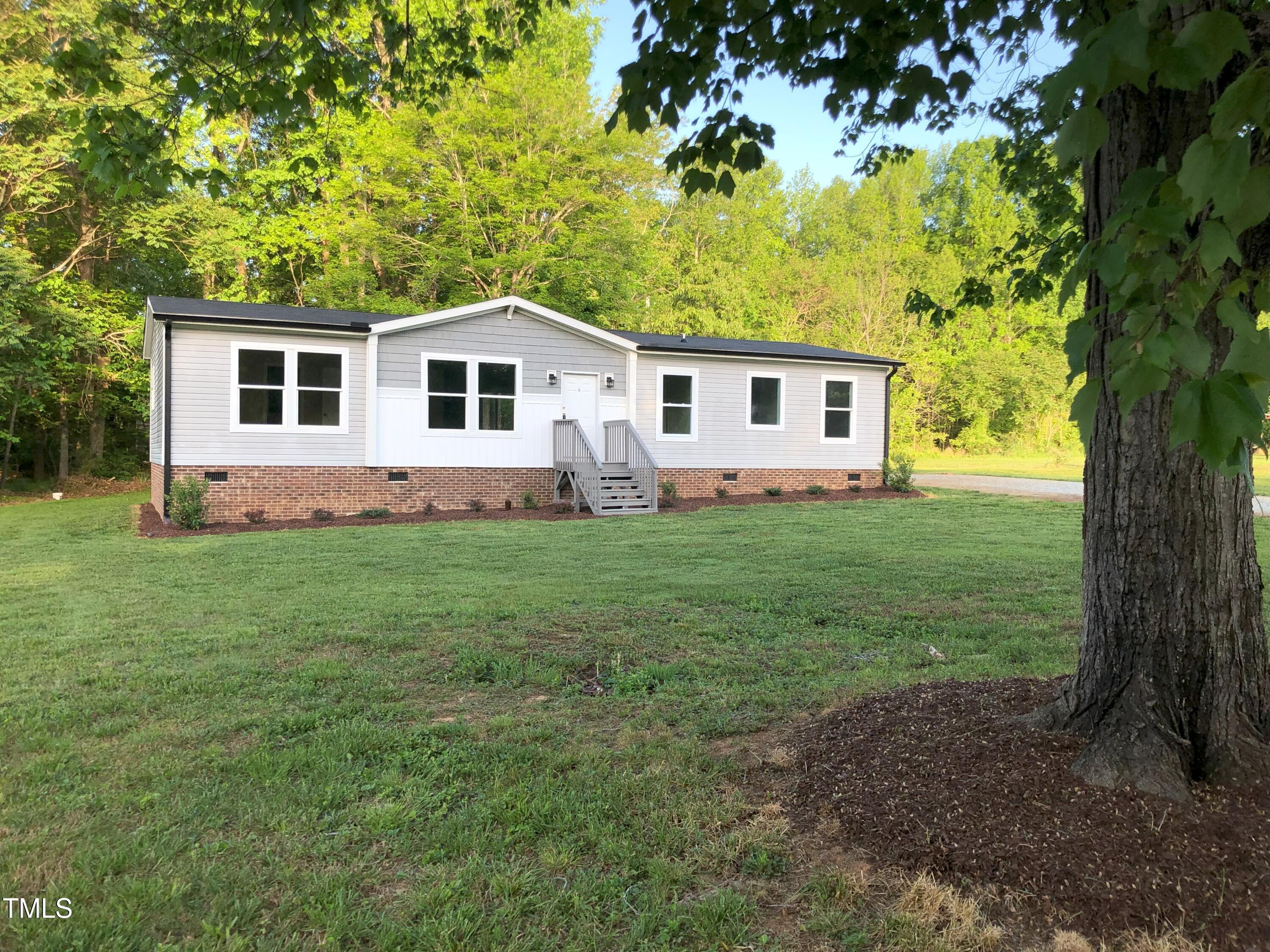 550 Saplin Branch Road Timberlake, NC 27583 - Photo 1 of 33 a view of a house with yard and a tree