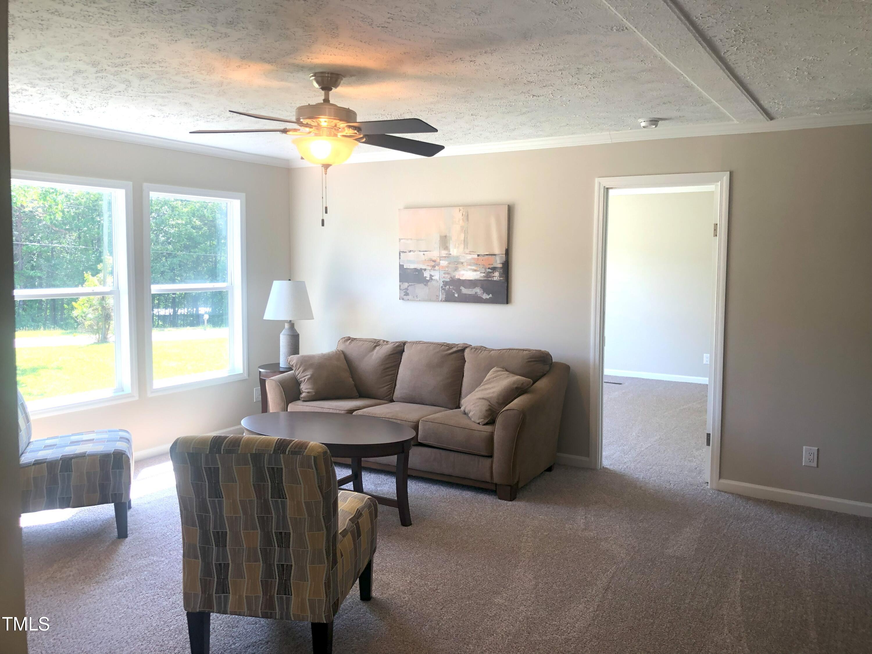 550 Saplin Branch Road Timberlake, NC 27583 - Photo 15 of 33 a living room with furniture and a large window