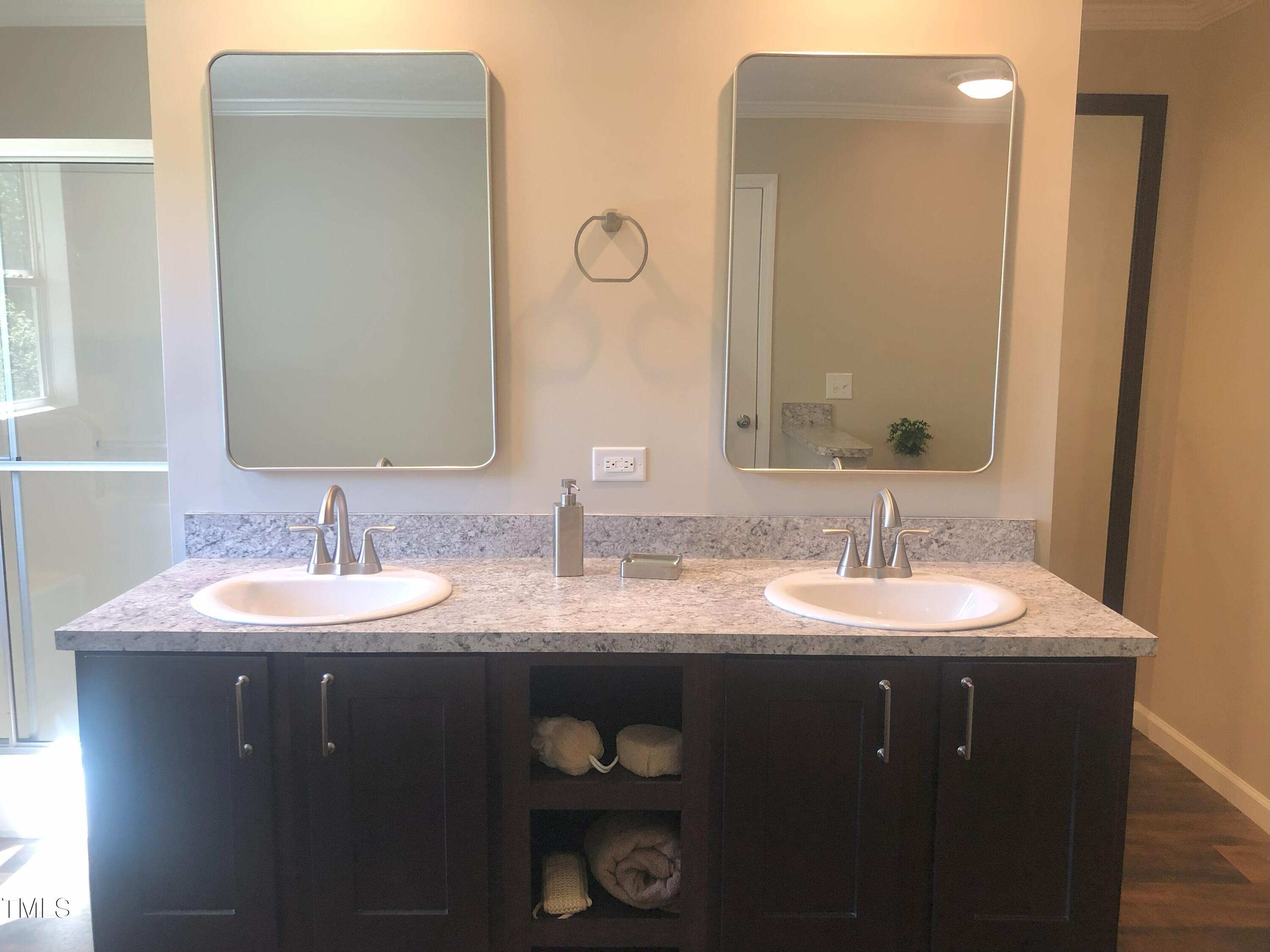 550 Saplin Branch Road Timberlake, NC 27583 - Photo 21 of 33 a bathroom with double sink and a mirror