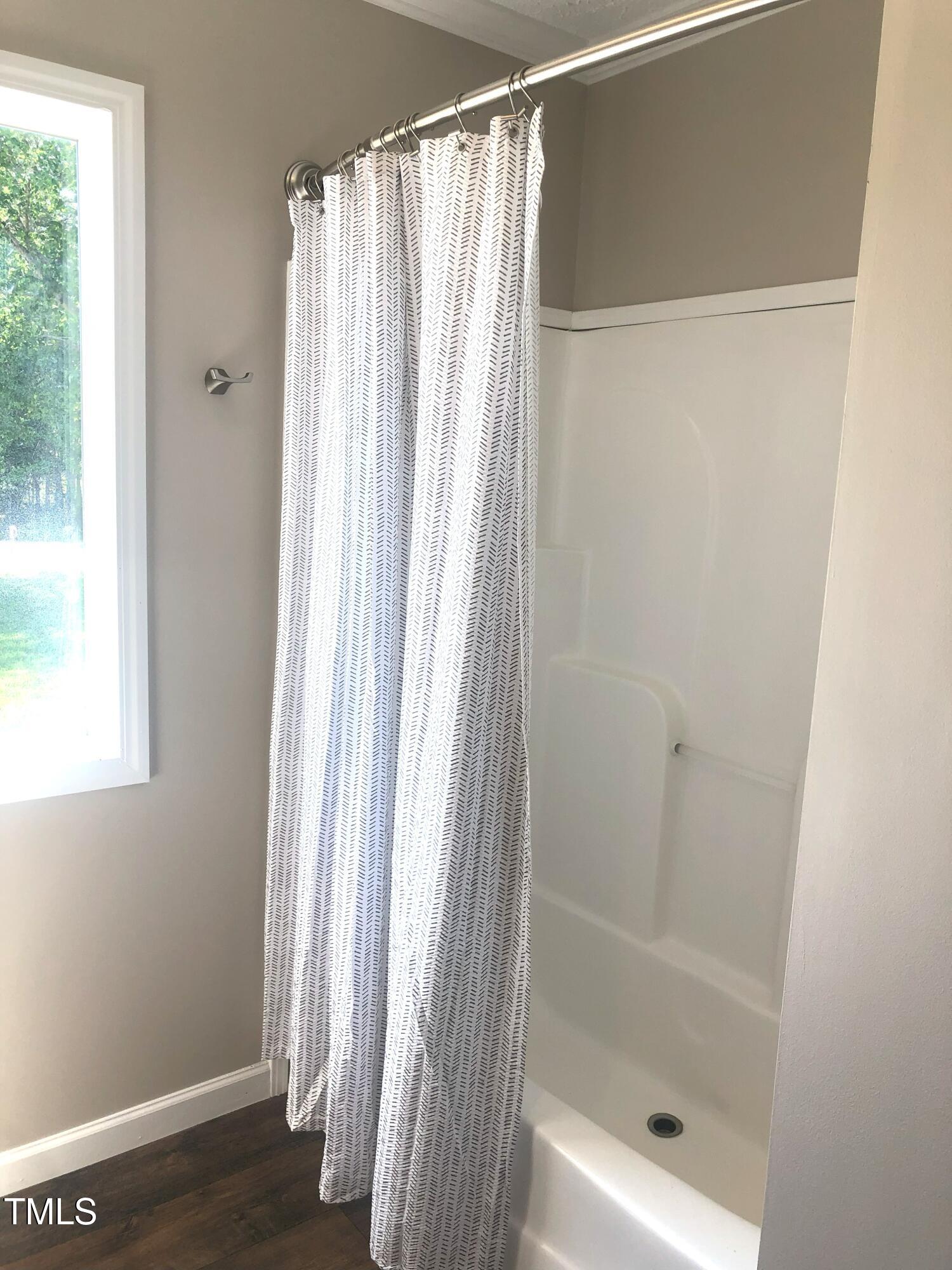 550 Saplin Branch Road Timberlake, NC 27583 - Photo 25 of 33 a bathroom with a shower and a window