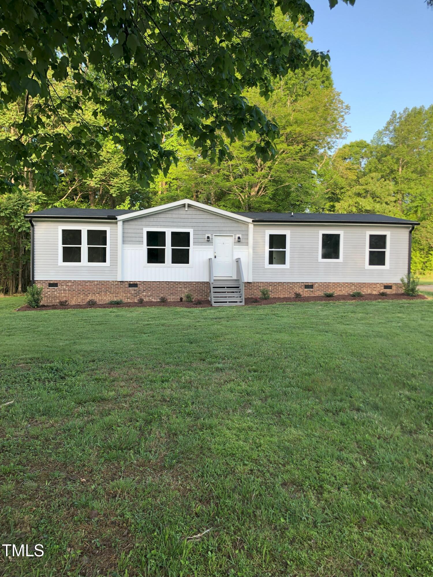 550 Saplin Branch Road Timberlake, NC 27583 - Photo 26 of 33 a view of a house with a backyard